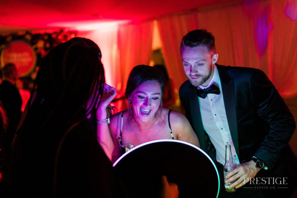 Guests looking at their photos taken on the Roamer Ipad Booth