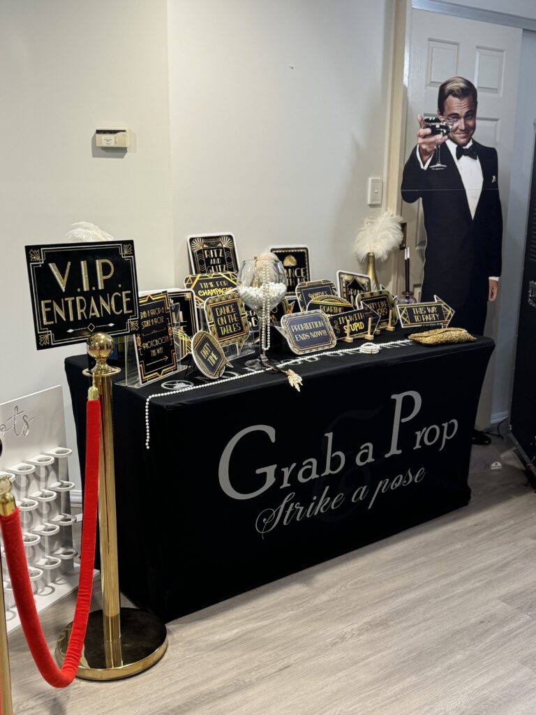 Gatsby-themed event entertainment featuring Art Deco styling, interactive photo experiences, vintage props, and Roaring Twenties-inspired décor.