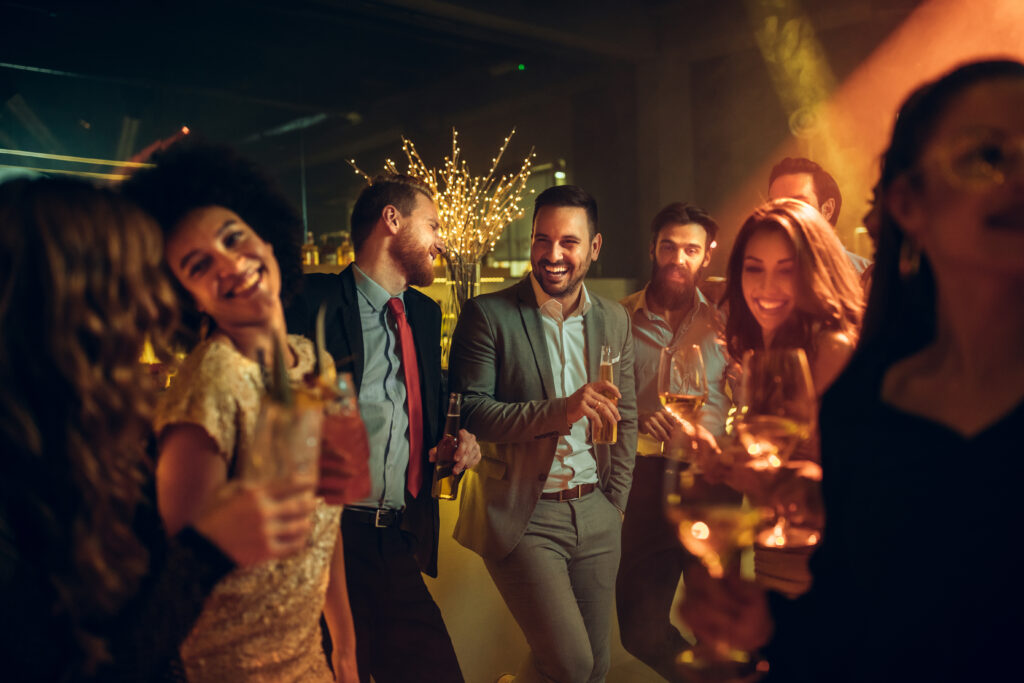 group office people partying night away laughing holding wine glasses
